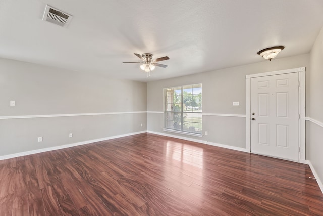 unfurnished room featuring ceiling fan and dark wood-type flooring