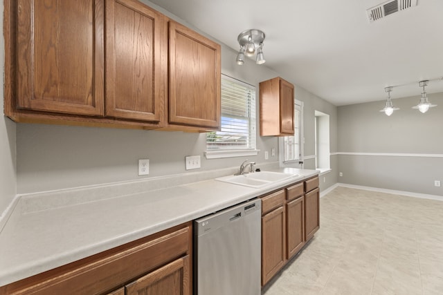 kitchen featuring sink, hanging light fixtures, and dishwasher