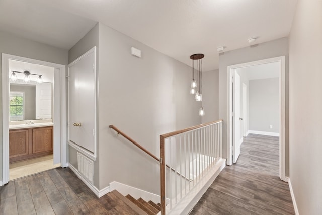 2700 Breezy Point Cv, Round Rock, TX 78665 - corridor featuring an upstairs landing and dark wood-style floors
