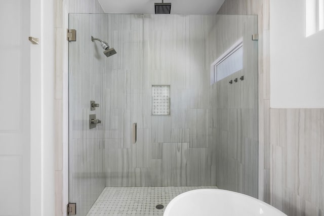 bathroom featuring independent shower and bath