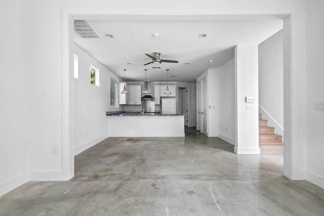 unfurnished living room featuring ceiling fan