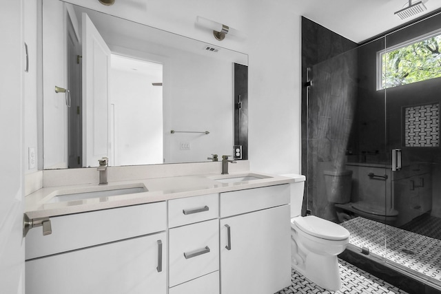 bathroom featuring toilet, tile patterned floors, walk in shower, and vanity