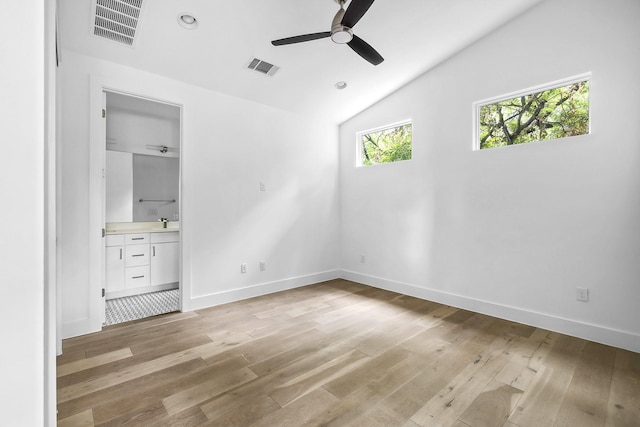 unfurnished bedroom featuring lofted ceiling, sink, ceiling fan, ensuite bathroom, and light hardwood / wood-style flooring