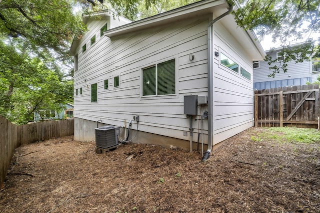 view of side of home with central air condition unit