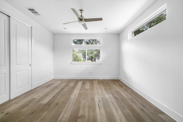 unfurnished bedroom with ceiling fan, a closet, and light hardwood / wood-style floors