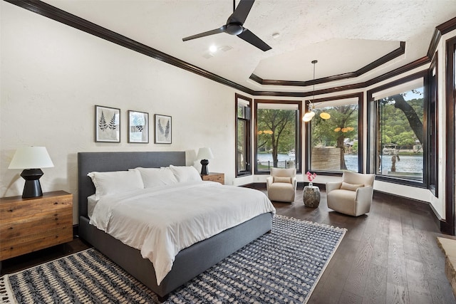 bedroom featuring dark hardwood / wood-style flooring, a textured ceiling, ornamental molding, and ceiling fan