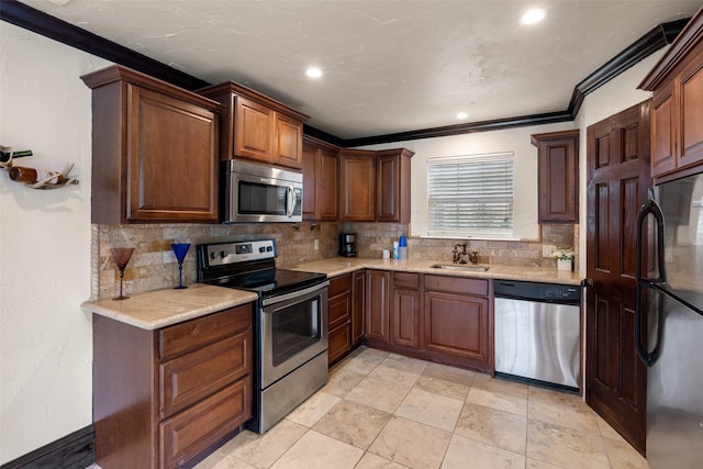 kitchen featuring sink, crown molding, stainless steel appliances, and backsplash