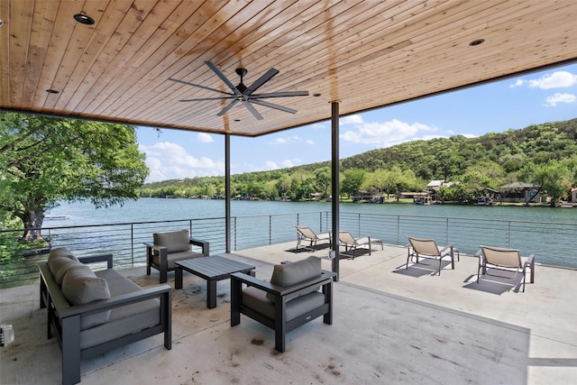 view of patio featuring an outdoor living space, a water view, and ceiling fan