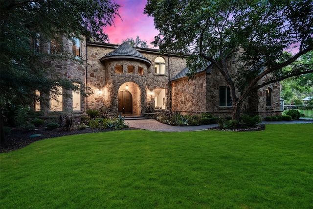 english style home with a lawn