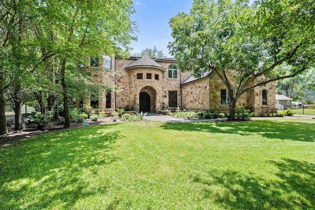 mediterranean / spanish home with a front lawn