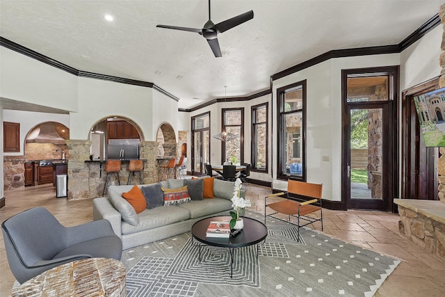 living room with ceiling fan and a textured ceiling