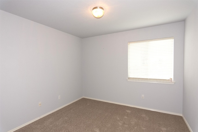 carpeted spare room featuring a wealth of natural light