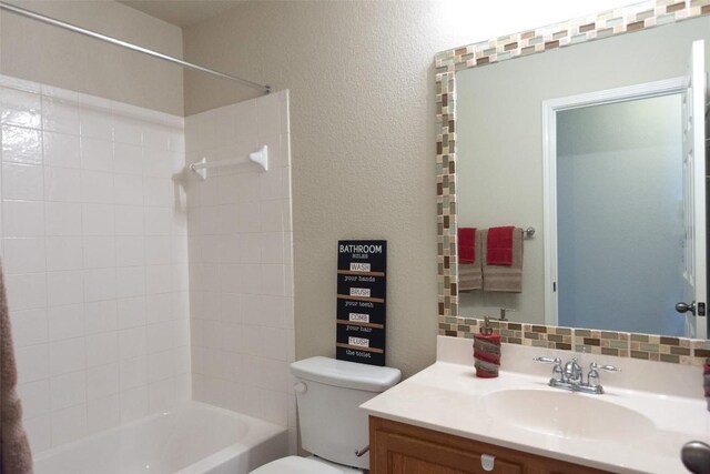 full bathroom featuring vanity, toilet, and tiled shower / bath