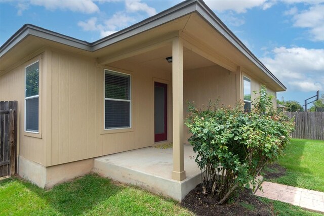 back of house with a yard and a patio area