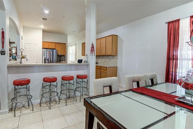 dining space featuring light tile patterned flooring