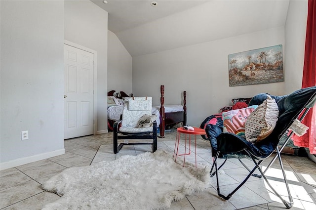 living area with light tile patterned floors and vaulted ceiling