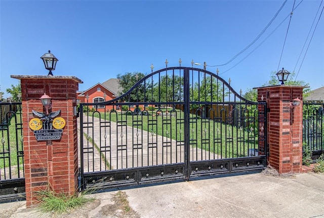 view of gate featuring a yard