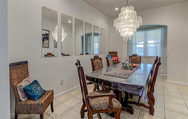 tiled dining space featuring a notable chandelier