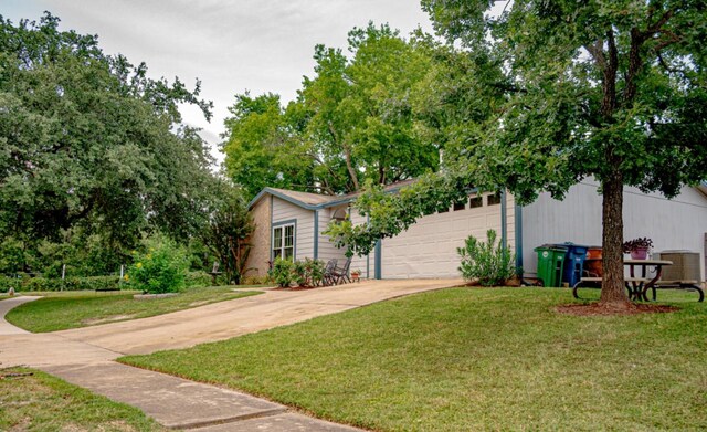 view of front of house with a garage and a front yard