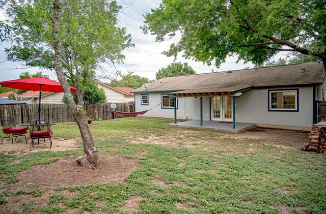 view of yard featuring french doors and a patio