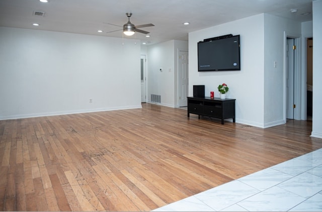 living room with light hardwood / wood-style flooring and ceiling fan