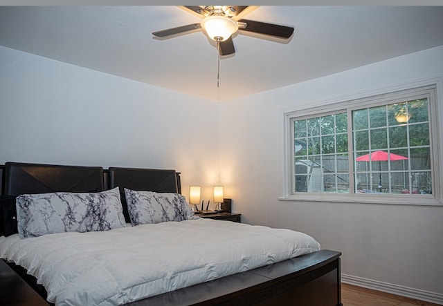 bedroom featuring hardwood / wood-style floors and ceiling fan