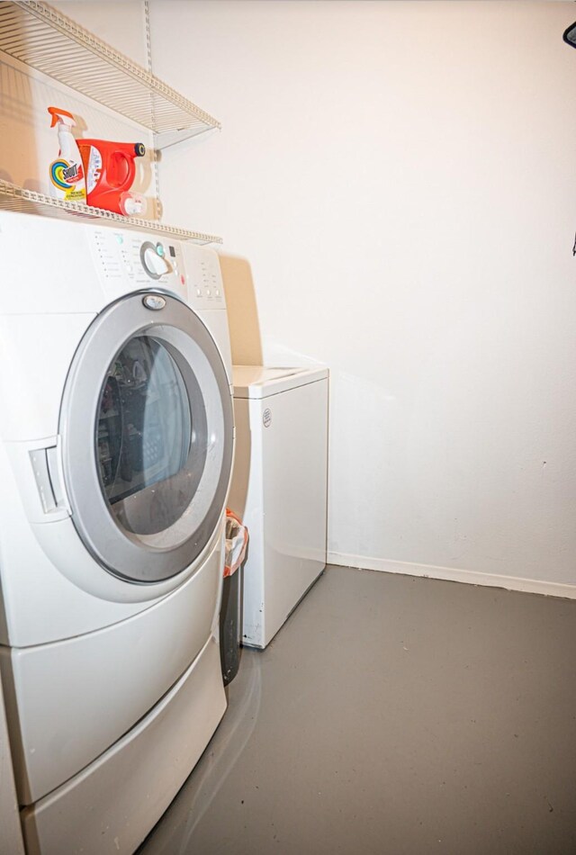 clothes washing area featuring washer and dryer