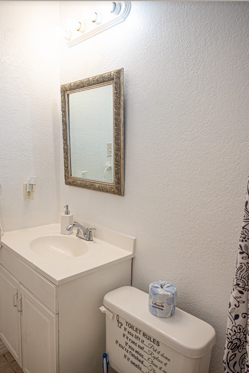 bathroom featuring vanity and toilet