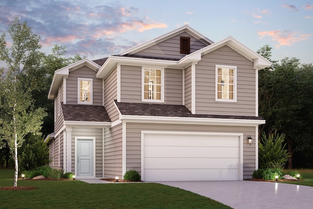 view of front facade featuring a garage and a yard