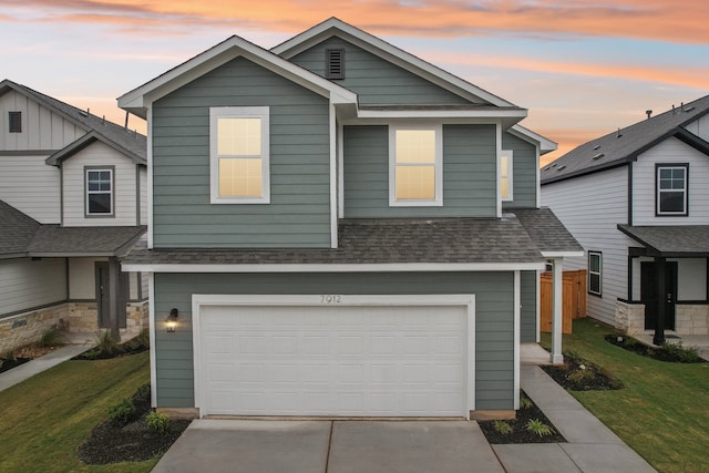 view of front of property featuring a garage and a yard