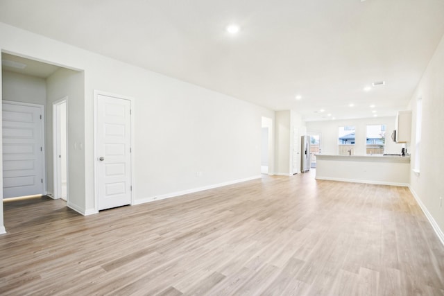 unfurnished living room with light wood-type flooring