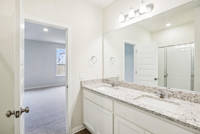 bathroom featuring walk in shower and vanity