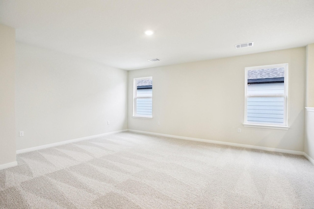 unfurnished room with light carpet