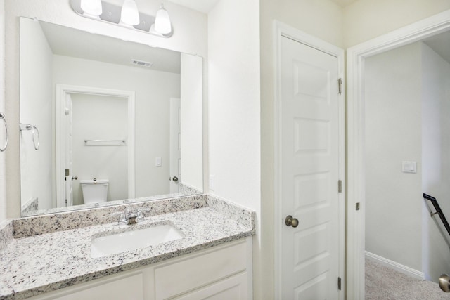 bathroom with vanity and toilet