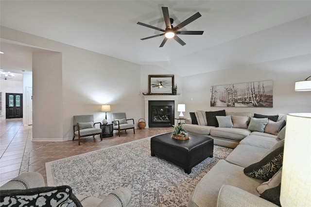 tiled living room with ceiling fan and lofted ceiling