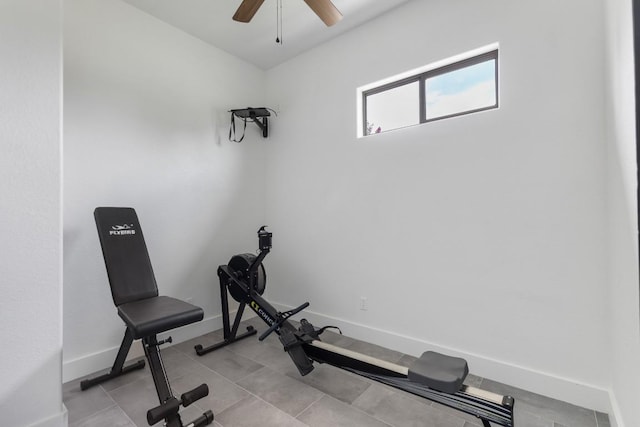 exercise room with baseboards and ceiling fan