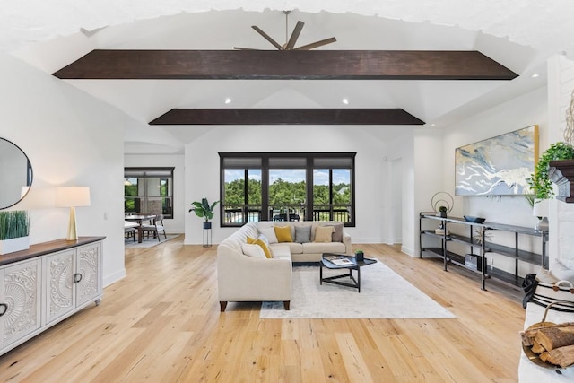 living room with lofted ceiling with beams, baseboards, light wood-type flooring, and ceiling fan