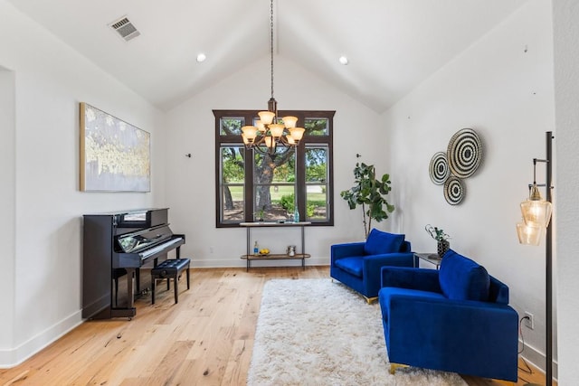 living area with visible vents, baseboards, a chandelier, light wood-type flooring, and high vaulted ceiling