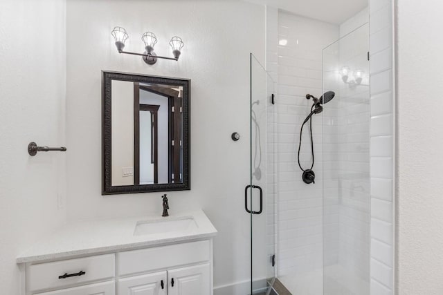 bathroom featuring vanity and a shower stall