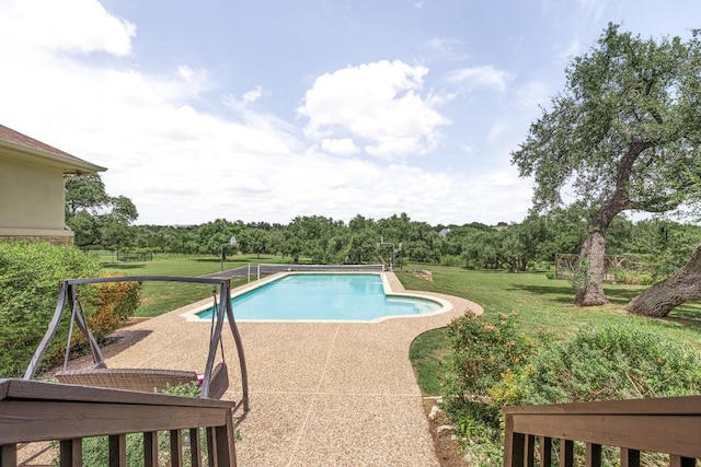 outdoor pool with a yard and a patio area