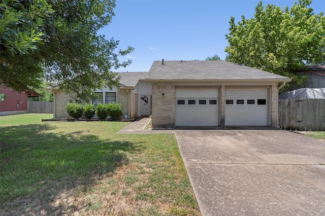 ranch-style house featuring a front yard and a garage