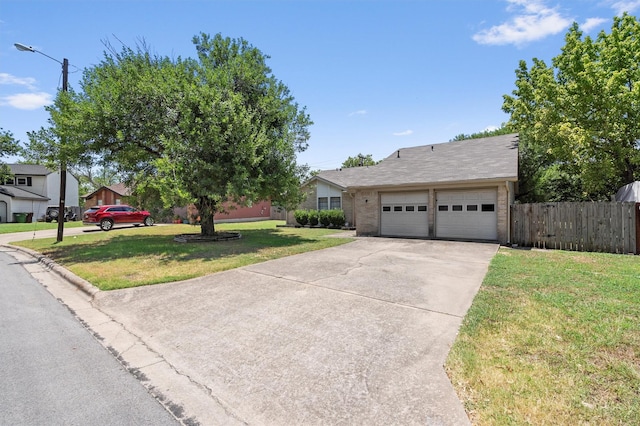 ranch-style house with a garage and a front lawn