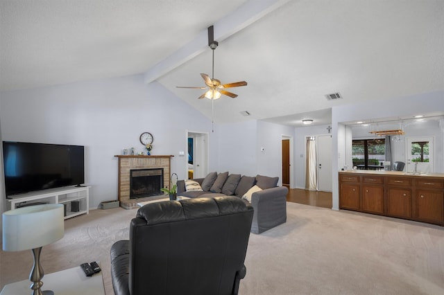 living room featuring a fireplace, light colored carpet, ceiling fan, and vaulted ceiling with beams