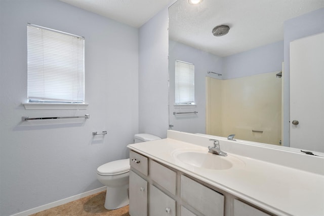 bathroom featuring a shower, toilet, and vanity