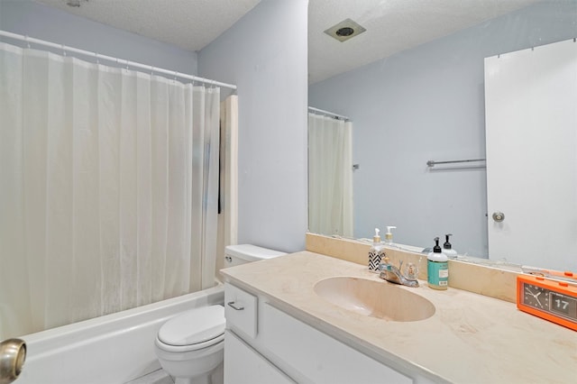 full bathroom featuring vanity, toilet, shower / bath combo, and a textured ceiling