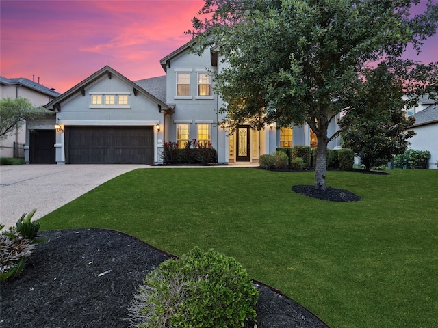 view of front facade featuring concrete driveway, stucco siding, an attached garage, and a front yard