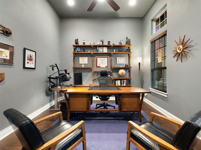 office area with dark wood finished floors, a ceiling fan, and baseboards