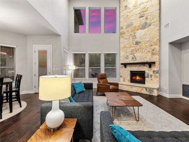 3417 Flat Iron Ct, Leander, TX 78641 - living room featuring wood finished floors, a fireplace, and a towering ceiling