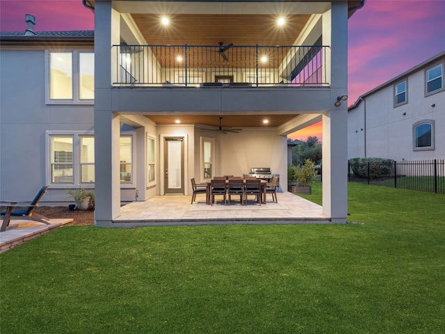 3417 Flat Iron Ct, Leander, TX 78641 - back of property at dusk with a balcony, a ceiling fan, a patio area, and stucco siding
