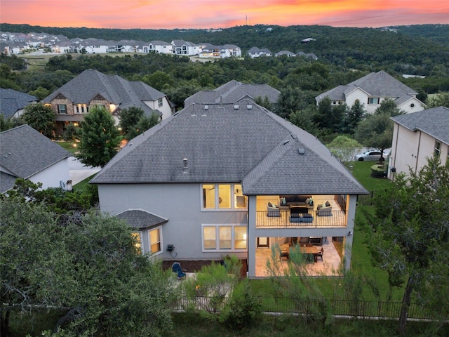3417 Flat Iron Ct, Leander, TX 78641 - back of property with a shingled roof, a balcony, a patio area, and a residential view